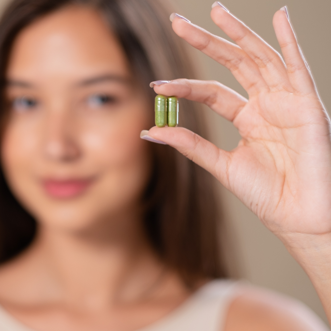 woman holding a capsule supplement