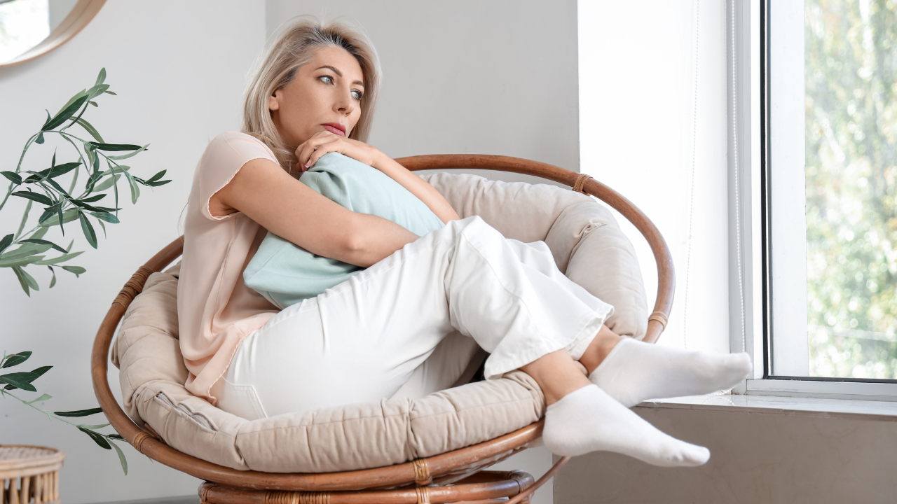 woman sitting curled up on chair